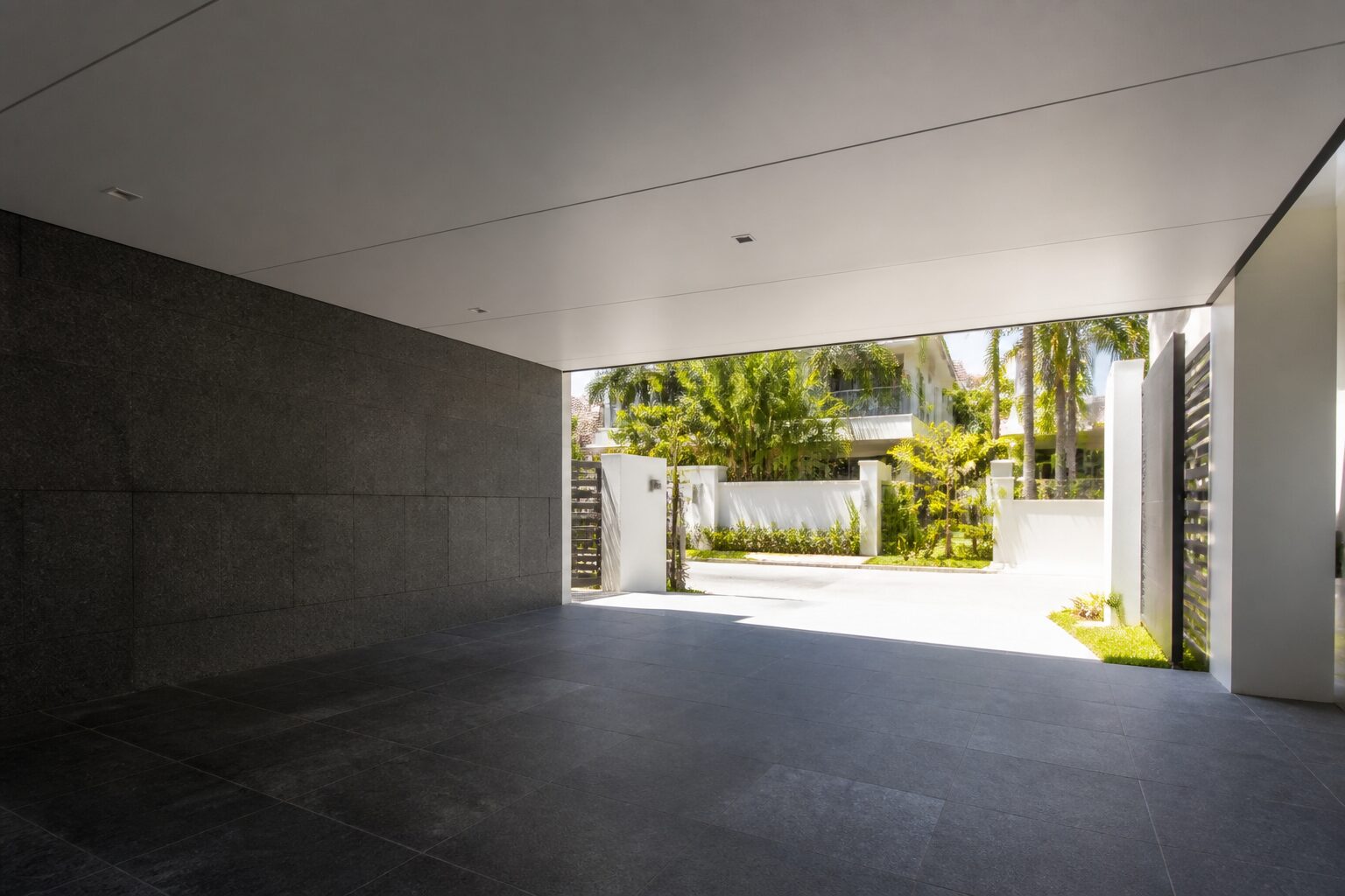 The underside of a Heat-Shield insulated aluminium car porch roof, looking out to a bright Singapore driveway