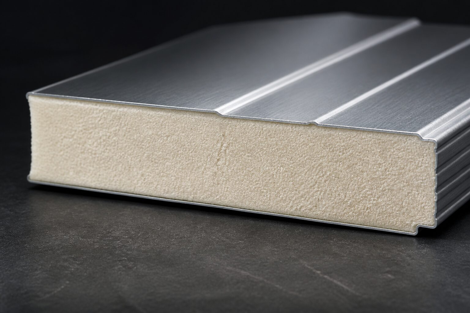 Macro photograph of the cut edge of an insulated aluminium roofing panel